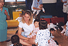Photo of Roxanne, Dr. Zhang and the orphanage children