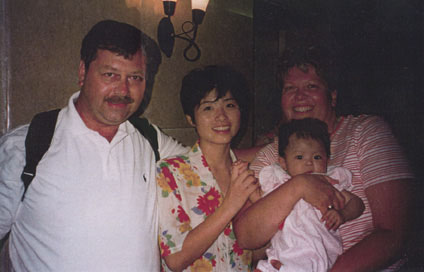 Photo of Dad, Mom, Riley and Orphanage Worker